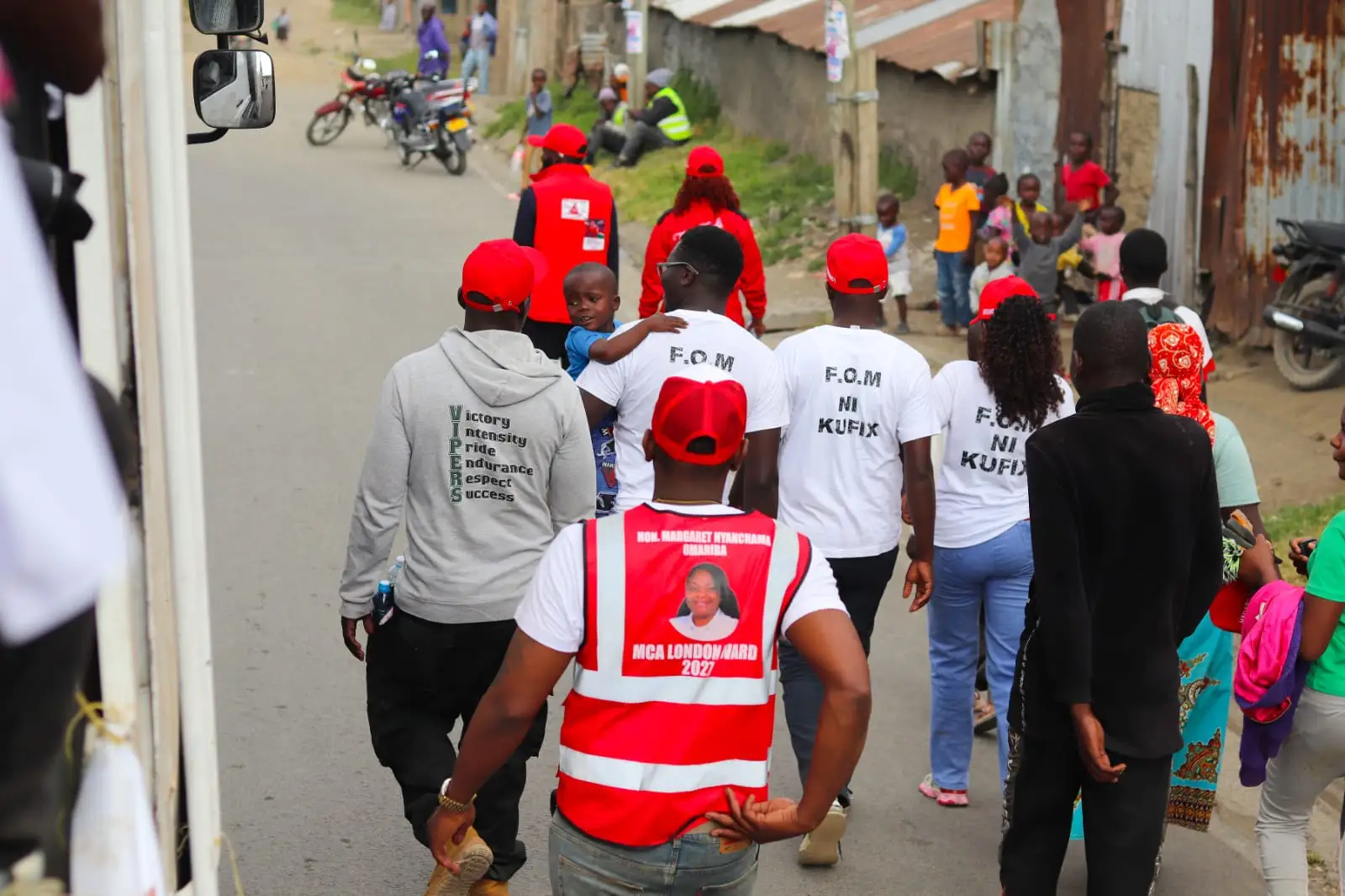 Youth walking in white F.O.M ni Kufix shirts