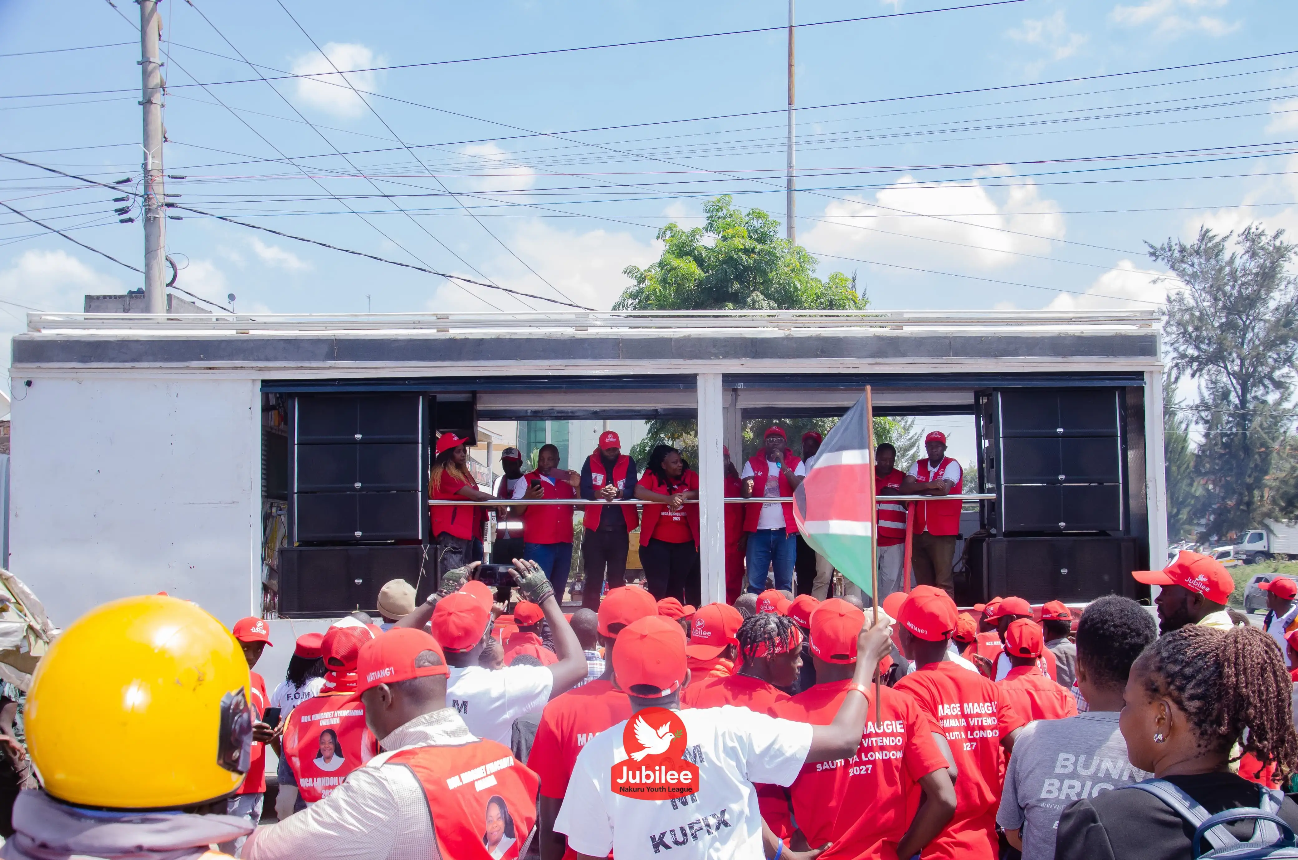 Supporters gathered around a stage truck
