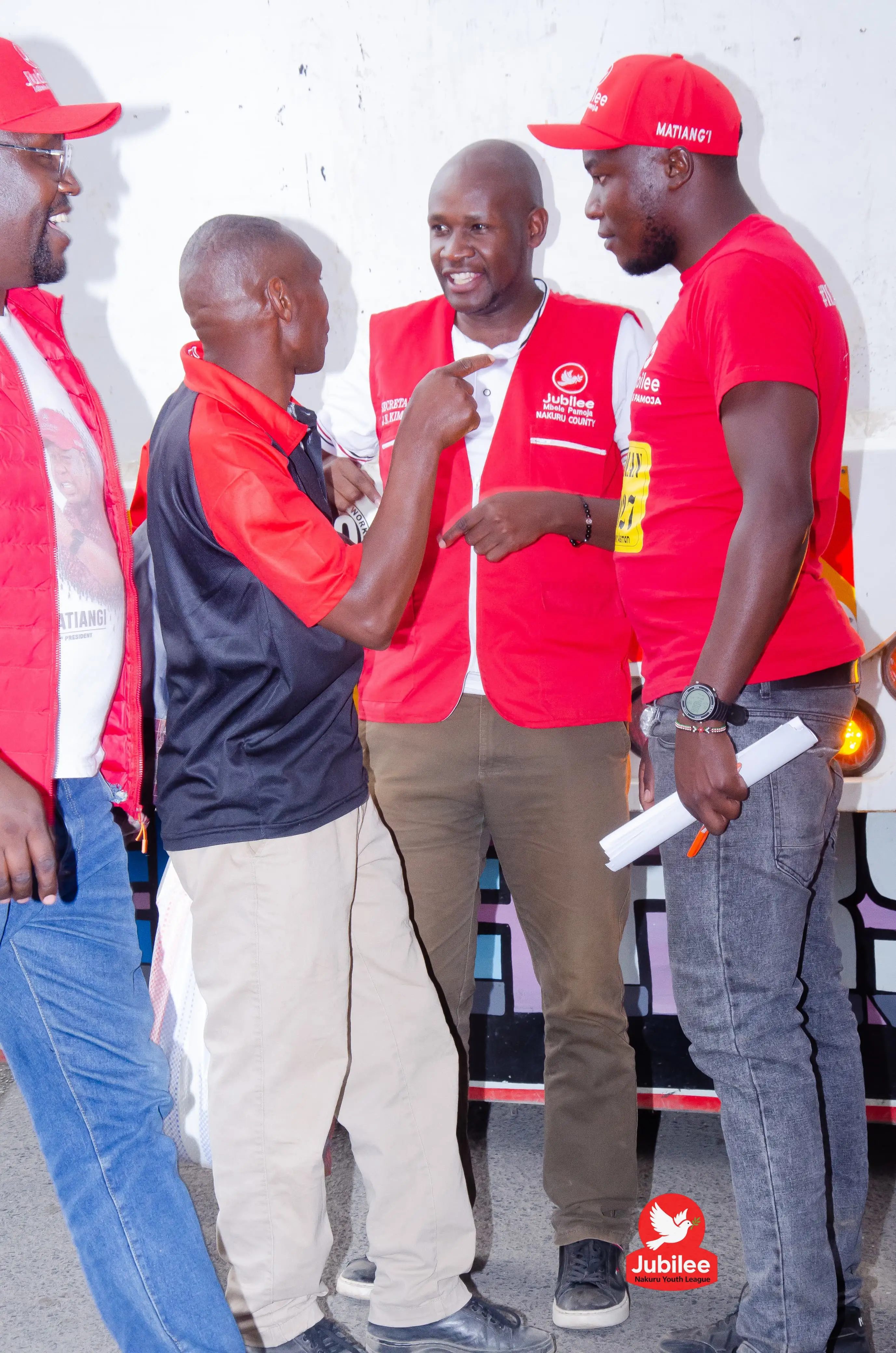 Three men in red Jubilee gear in conversation
